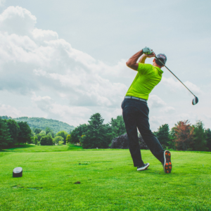 golfer mid swing on golf course demonstrating fluid swing performance with SwingFree mobility system